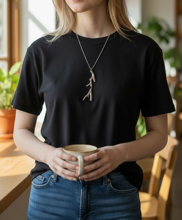 Long steel necklace with abstract charm 