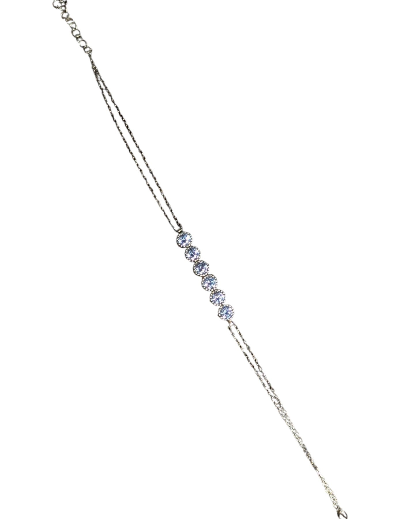 Delicate silver-tone line bracelet featuring five round yellow cubic zirconia stones.